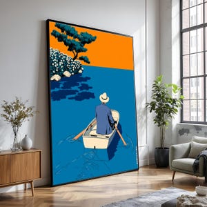 May include: Large framed art print depicting a person in a boat on blue water, with an orange sky and a tree on the left. The person wears a blue jacket and a white hat. The artwork has a minimalist, graphic style.