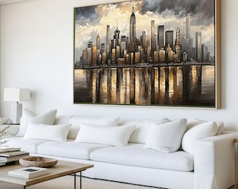 May include: A large framed canvas art piece depicting a cityscape with a water reflection. The artwork features a skyline of tall buildings in shades of gold, brown, and black, set against a cloudy sky. The painting is displayed above a white sofa.
