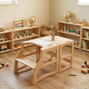 Puede incluir: Una mesa infantil de madera clara con diseño de taburete. La mesa tiene una parte superior cuadrada con un recorte para una superficie de dibujo. Estanterías, juguetes y globos terráqueos están en el fondo, lo que sugiere un entorno de sala de juegos.