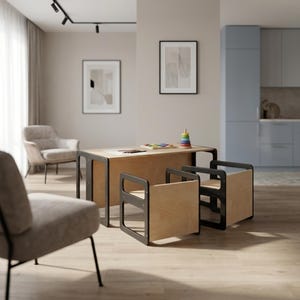 May include: A child's wooden table and two chairs set. The table and chairs have a natural wood finish with black frames. A colorful toy is on the table. The set is in a modern, minimalist interior setting.