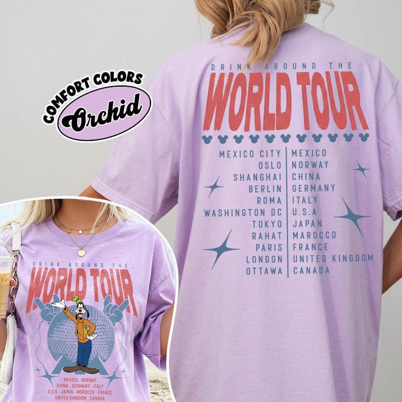 May include: Orchid-colored t-shirt with "Drink Around The World Tour" text in red. The front features a cartoon character and the tour name. The back lists cities like Tokyo, Paris, and London.
