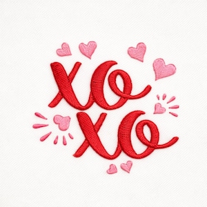 May include: Embroidered design featuring the letters "XO" in red, surrounded by pink hearts and radiating accents. The design is on a white fabric background, creating a Valentine's Day or romantic theme.