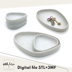May include: A set of three gray felt trays in various sizes, with a striped edge design. One tray holds keys. The text "Digital file STL+3MF" is visible. The trays are designed for organizing small items.