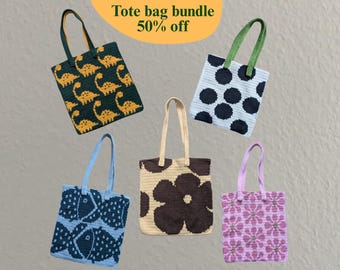 May include: A collection of five handmade tote bags with various patterns. Designs include dinosaurs, polka dots, fish, a large flower, and floral patterns. Each bag has a matching handle color. The text "Tote bag bundle 50% off" is visible.