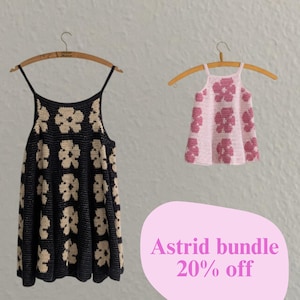 Pode incluir: Duas blusas de crochê em cabides de madeira. Uma é preta com estampas florais creme, a outra é rosa com estampas florais rosas. A imagem inclui o texto "Astrid bundle 20% off" em uma bolha rosa.
