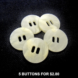 May include: Five round, off-white buttons with two holes each, arranged on a dark background. The buttons have a pearlescent sheen. The text "5 BUTTONS FOR $2.80" is at the bottom.