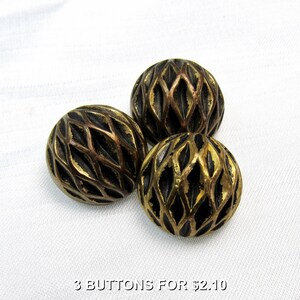May include: Three round buttons featuring a metallic bronze finish and a raised, diamond-shaped lattice pattern. The surface of each button displays a dark, recessed texture within the grid design, creating a high-contrast appearance.