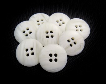May include: Eight white, round buttons with four holes each, arranged against a black background. The buttons have a marbled appearance. The text at the bottom reads "8 BUTTONS FOR $2.80".