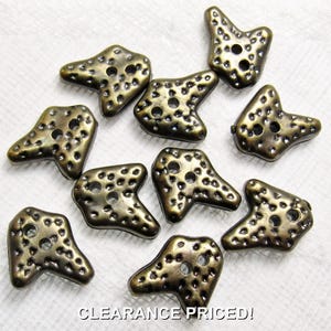 May include: A collection of ten irregular, bronze-toned buttons with a textured, pitted surface and two central holes. Each button features an asymmetrical, multi-pointed shape. The text CLEARANCE PRICED! is printed at the bottom of the image.