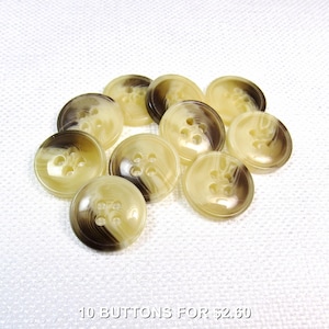 Könnte beinhalten: Zehn runde Knöpfe mit vier Löchern, in einem marmorierten Design aus hellbraun und dunkelbraun. Der Text "10 BUTTONS FOR $2.60" ist zu sehen. Geeignet für verschiedene Nähprojekte.