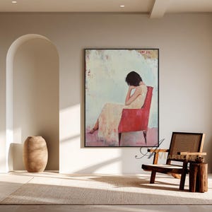 May include: An abstract painting depicts a person seated in a red chair, with a light-colored dress. The artwork is framed and hangs on a neutral-toned wall. A wooden chair and side table are in the foreground, with a large vase and arched doorway.