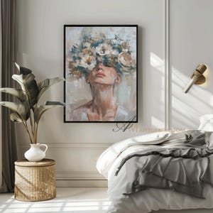 K&ouml;nnte beinhalten: Gerahmtes &Ouml;lgem&auml;lde, das eine Frau mit Blumenkrone zeigt. Das Kunstwerk verwendet eine ged&auml;mpfte Palette aus Beige, Wei&szlig; und Braun, mit cremefarbenen und gelben Blumen. Das Gesicht der Frau ist ruhig, mit geschlossenen Augen.