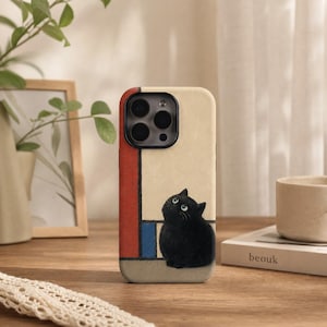 May include: A phone case featuring a black cat illustration against a cream background with red and blue geometric accents. The design includes a black camera cutout at the top. The cat is positioned at the bottom right, looking upward with wide eyes.