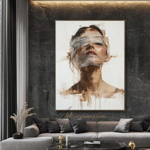 May include: An abstract portrait painting of a person with their eyes and mouth covered in a translucent material. The artwork features a neutral color palette with shades of brown and white, and is framed in gold.