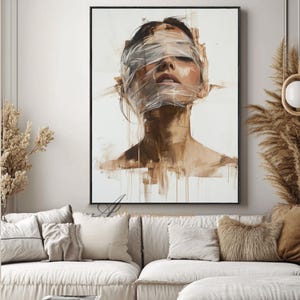 May include: An abstract painting of a person with their eyes closed and face wrapped in clear tape. The artwork uses a palette of browns and whites, with visible brushstrokes and a focus on texture. The painting is framed in a black border.