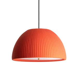 May include: Orange pendant light with a pleated lampshade. The dome-shaped shade has vertical pleats and a gradient color, transitioning from a darker orange at the top to a lighter orange at the bottom. The light hangs from a black cord.