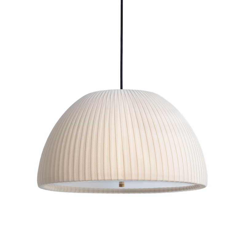 May include: Cream-colored, dome-shaped pendant light with vertical ribbed texture. The light hangs from a black cord and features a brass-colored accent at the bottom. The design is minimalist and modern, suitable for various interior styles.