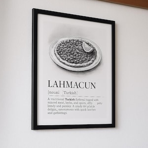 May include: Black framed print featuring a detailed illustration of Lahmacun, a Turkish flatbread topped with minced meat, herbs, and spices. The word "LAHMACUN" is displayed prominently, along with a definition.