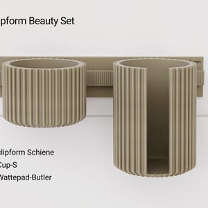 May include: A set of three ceramic mugs with a speckled, matte finish. The mugs are in shades of cream, light gray, and dark gray. Each mug has a simple, minimalist design, perfect for coffee or tea.