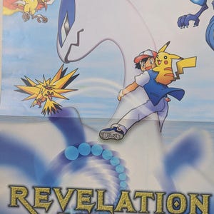 May include: A poster featuring characters from the Pokémon franchise. The poster includes the text "Revelation Lugia" and images of Lugia, Pikachu, and other Pokémon characters. The background is a gradient of blue and white.