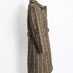 May include: A long, brown coat with a black geometric pattern. The coat has a belt and a collar.