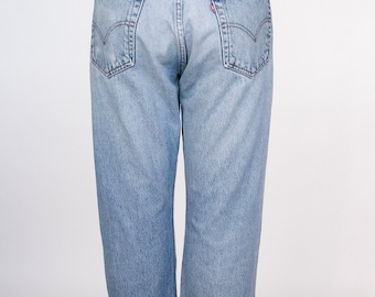 May include: Light blue denim jeans with a high waist and a straight leg. The jeans have a classic five-pocket style and a Levi's patch on the back.