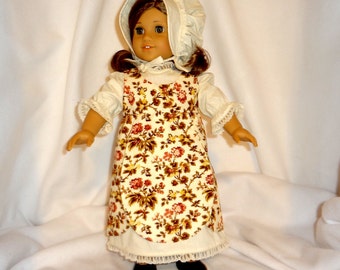 Four-piece outfit, for 18 inch dolls.  Dress, Jumper, Pantaloons, and Bonnet.