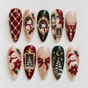 May include: A set of ten almond-shaped press-on nails featuring Christmas designs. The collection includes motifs of snowmen, decorated pine trees, red bows, holly berries, gold frames, and pearl accents in a palette of deep red, forest green, and cream.
