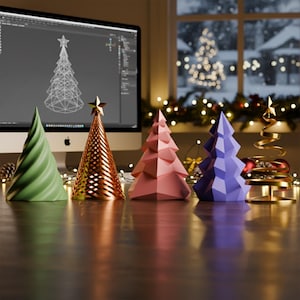 May include: A collection of decorative Christmas trees in various colors and designs. Includes a green spiral tree, a copper-colored openwork tree, a pink geometric tree, a purple geometric tree, and a gold spiral tree. The trees are on a wooden surface.