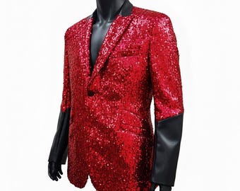 May include: A red sequinned blazer featuring a single-button closure, a notched lapel collar in black, and long sleeves with solid black cuffs. The main body of the jacket is covered in reflective red sequins, providing a textured appearance.