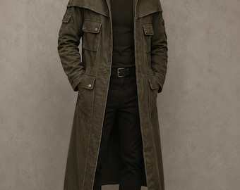 May include: An olive green long trench coat featuring a high collar, multiple flap pockets on the chest and hips, and a front zipper closure. The coat is worn over a dark green t-shirt, black trousers with a belt, and dark brown leather lace-up boots.