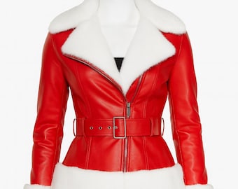 May include: A red leather jacket with white faux fur trim on the collar, cuffs, and hem. The jacket has a belted waist, a zip closure, and a white faux fur collar. The jacket is displayed on a mannequin.