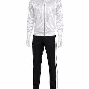 May include: A white satin track suit with rhinestone embellishments. The jacket has a zip-up front and a high collar. The black pants have a white stripe down the side. The outfit is displayed on a mannequin.
