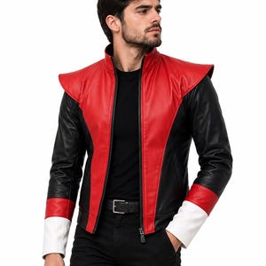 May include: A jacket featuring a red front panel with a high collar, black sleeves, and a red and white color-blocked cuff design. The jacket has a central black zipper closure and structured shoulder detailing, worn over a plain black shirt and black pants.