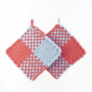 May include: Two woven pot holders, one blue and one red, with a chequered pattern. The pot holders are made of cotton yarn and are ideal for protecting your hands from hot surfaces.
