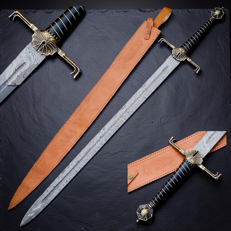 Op de afbeelding: Een lang zwaard met een patroon van Damascusstaal, een zwart handvat met gouden draadwikkeling en een messing stootplaat met een waaiervormig ontwerp. Het zwaard wordt vergezeld door een beige lederen schede met reli&euml;f bloemmotieven.