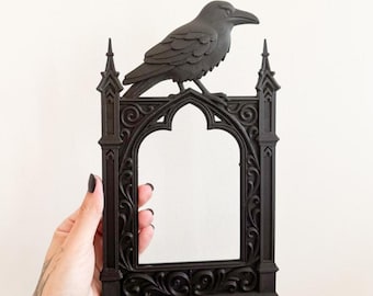 May include: Black raven perched atop a gothic-style frame. The frame has an arched opening and ornate detailing. The image includes the text "STL + 3MF FILE" and "DIGITAL FILE FOR 3D PRINTING".