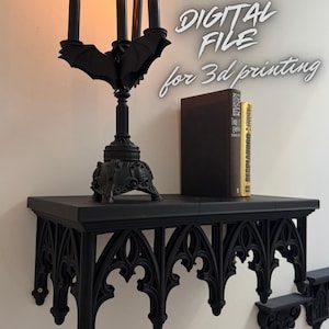 May include: A black gothic-style shelf with a matching bat-shaped candelabra holding four lit candles. A book sits on the shelf. The text "DIGITAL FILE for 3d printing" is visible.