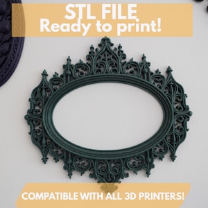 May include: A dark teal oval frame with ornate detailing, ready to print. The frame has an open center and is compatible with all 3D printers. The text "STL FILE Ready to print!" is displayed above the frame.