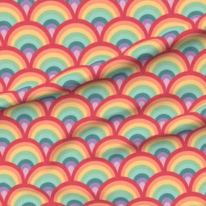 May include: A fabric with a repeating pattern of colorful rainbows in shades of red, orange, yellow, green, blue, and purple. The rainbow arches are layered on a red background, creating a textured, wave-like effect.