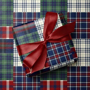 May include: A wrapped gift with a burgundy ribbon bow. The gift is wrapped in a patchwork of plaid patterns in red, green, blue, and white. The background is a matching patchwork plaid pattern.