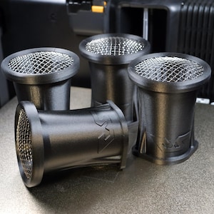May include: Four matte black cylindrical air intake ducts with flared openings and silver metal mesh grilles covering the tops. Each unit features a molded logo on the side, with three standing upright and one lying horizontally on its side.
