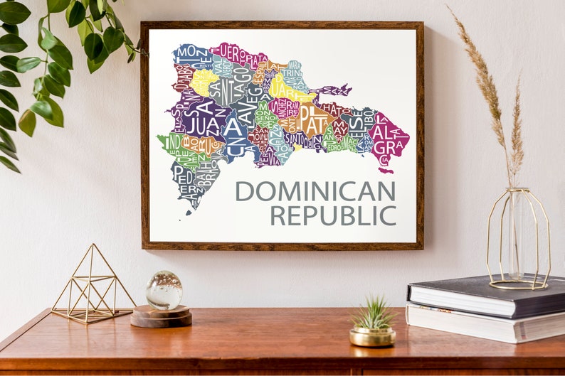 May include: A framed print of a map of the Dominican Republic. The map is made up of the names of the provinces in the country, each province is a different color. The text "DOMINICAN REPUBLIC" is printed below the map.