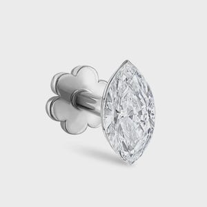 May include: A silver-toned stud earring featuring a marquise-cut clear gemstone set in a metal prong setting. The earring includes a flat, flower-shaped backing piece attached to a straight post, designed for secure placement in a pierced earlobe.