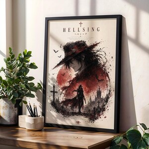 May include: A framed poster featuring Hellsing artwork with a central figure in a wide-brimmed hat against a large red moon. The illustration includes a silhouette of a character, a gothic castle, crosses, and bats, with the text Hellsing at the top.