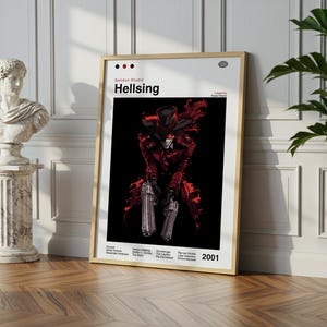 May include: A framed poster of the anime series Hellsing, depicting a character in red and black attire, holding two silver pistols. The poster is titled "Hellsing" and the year "2001" is printed on it. The poster is propped against a white wall.