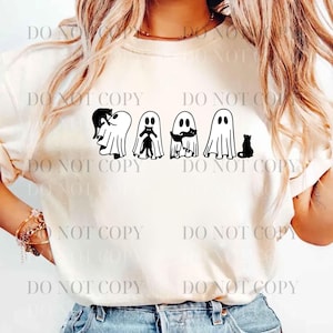 May include: A cream-coloured sweatshirt with a black graphic of four ghosts and four black cats. The ghosts have different cat companions. The design is centered on the front of the shirt. The shirt has long sleeves.
