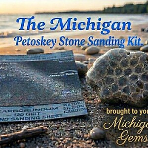 May include: The Michigan Petoskey Stone Sanding Kit includes a 120 grit carborundum hand sanding sheet and three sheets of high-quality sandpaper. A textured, fossilized Petoskey stone is positioned next to the dark gray sanding sheet.