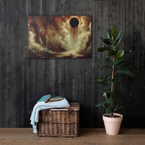 May include: A canvas print featuring a surreal landscape with a dark, ominous orb in a cloudy sky. The artwork uses a palette of browns, reds, and creams, creating a dramatic and atmospheric scene. A wicker basket with books and a blanket sits below the artwork.