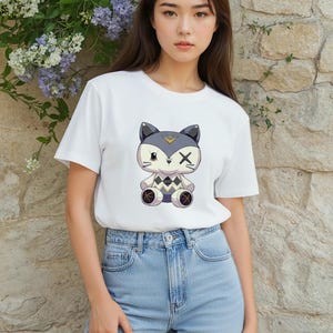 May include: White t-shirt featuring a cartoon fox design with gray, black, and yellow accents. The fox has an X over one eye and a diamond pattern on its chest. The shirt is paired with light blue jeans.